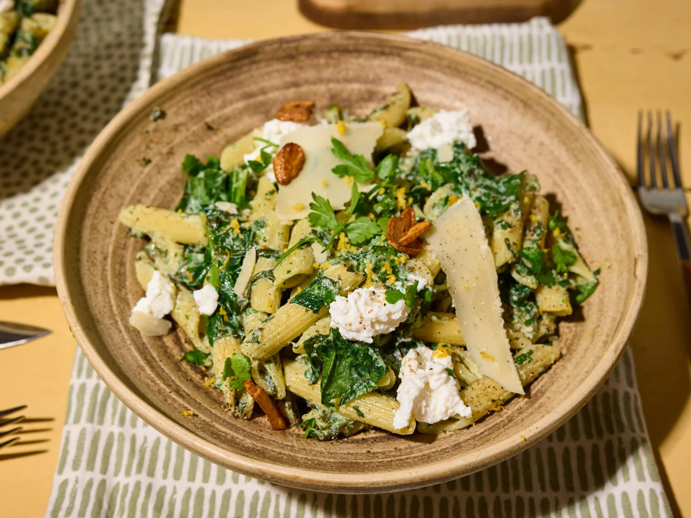 Creamy penne pasta served with spinach and ricotta cheese