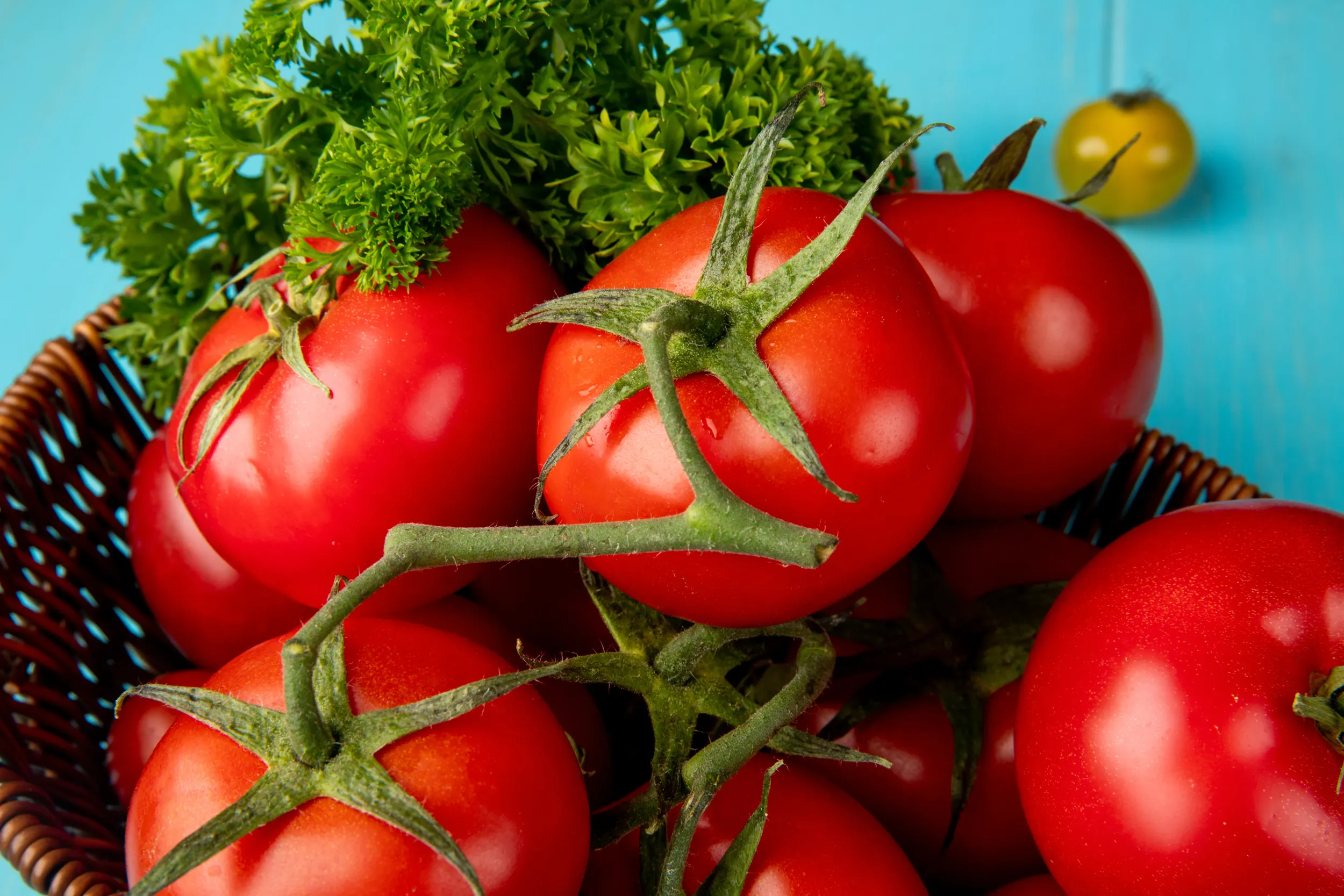 close-up-view-vegetables-as-coriander-tomato-basket-blue-surface