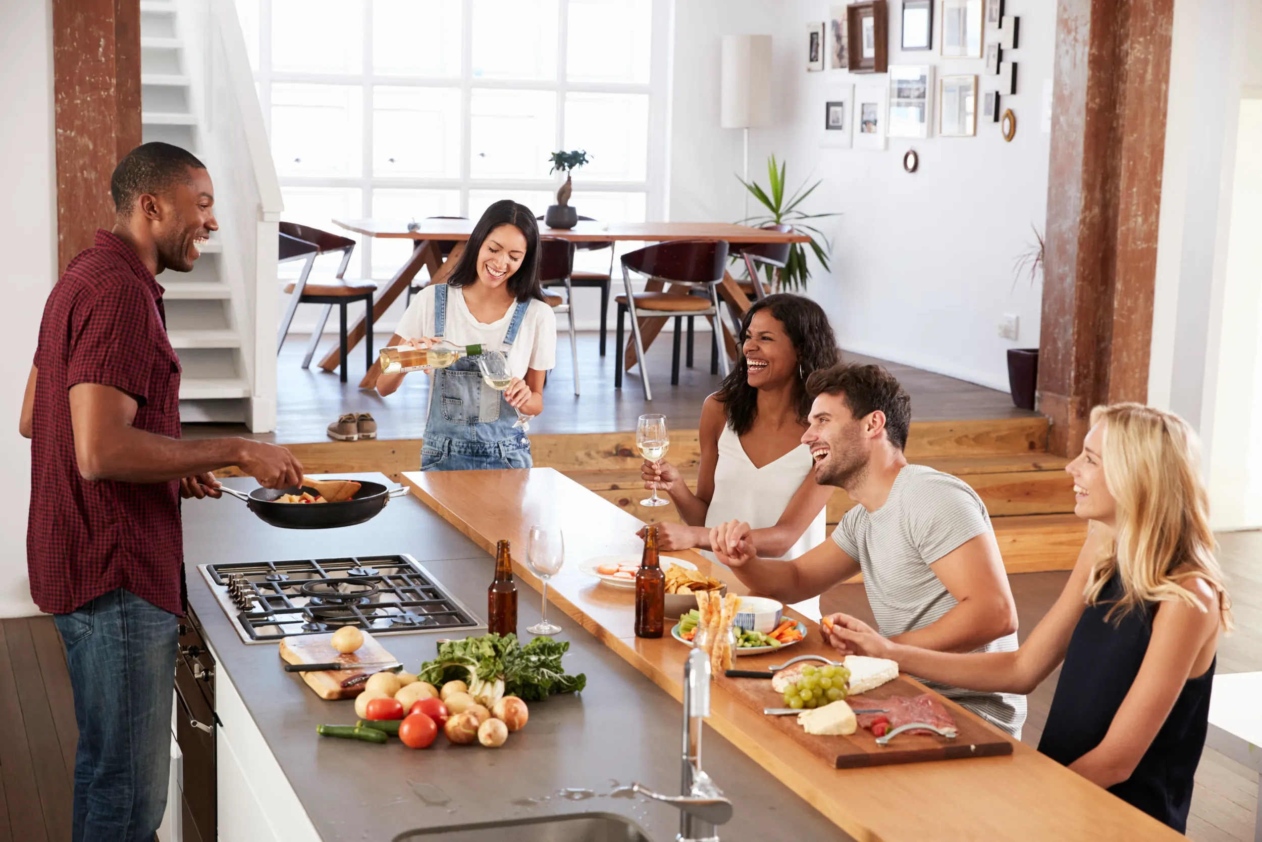friends-prepare-serve-food-dinner-party-home-together