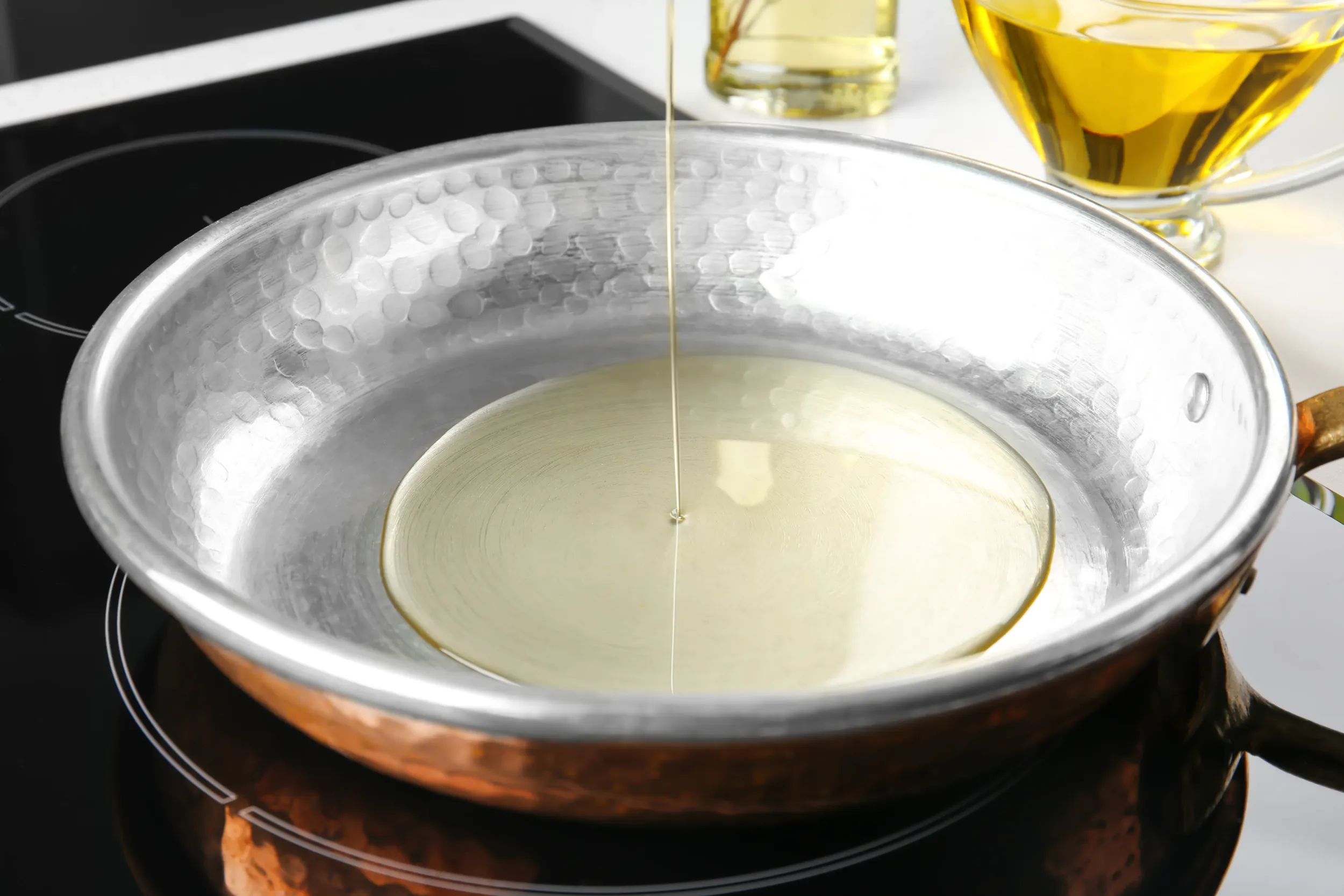 pouring-oil-into-frying-pan-closeup