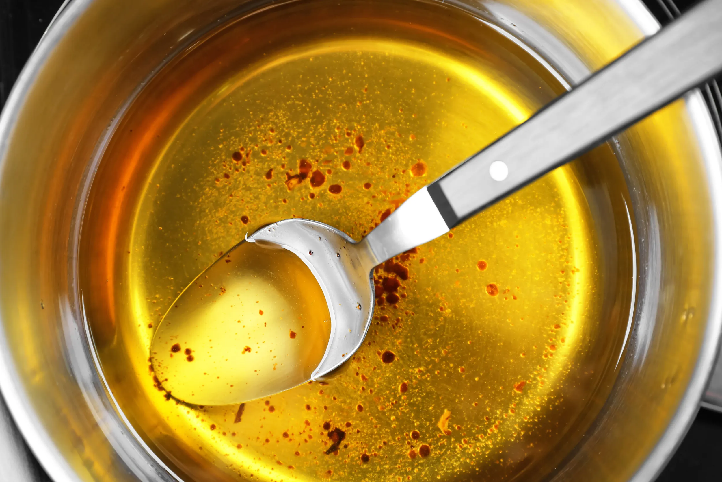 saucepan-with-used-vegetable-oil-spoon-closeup