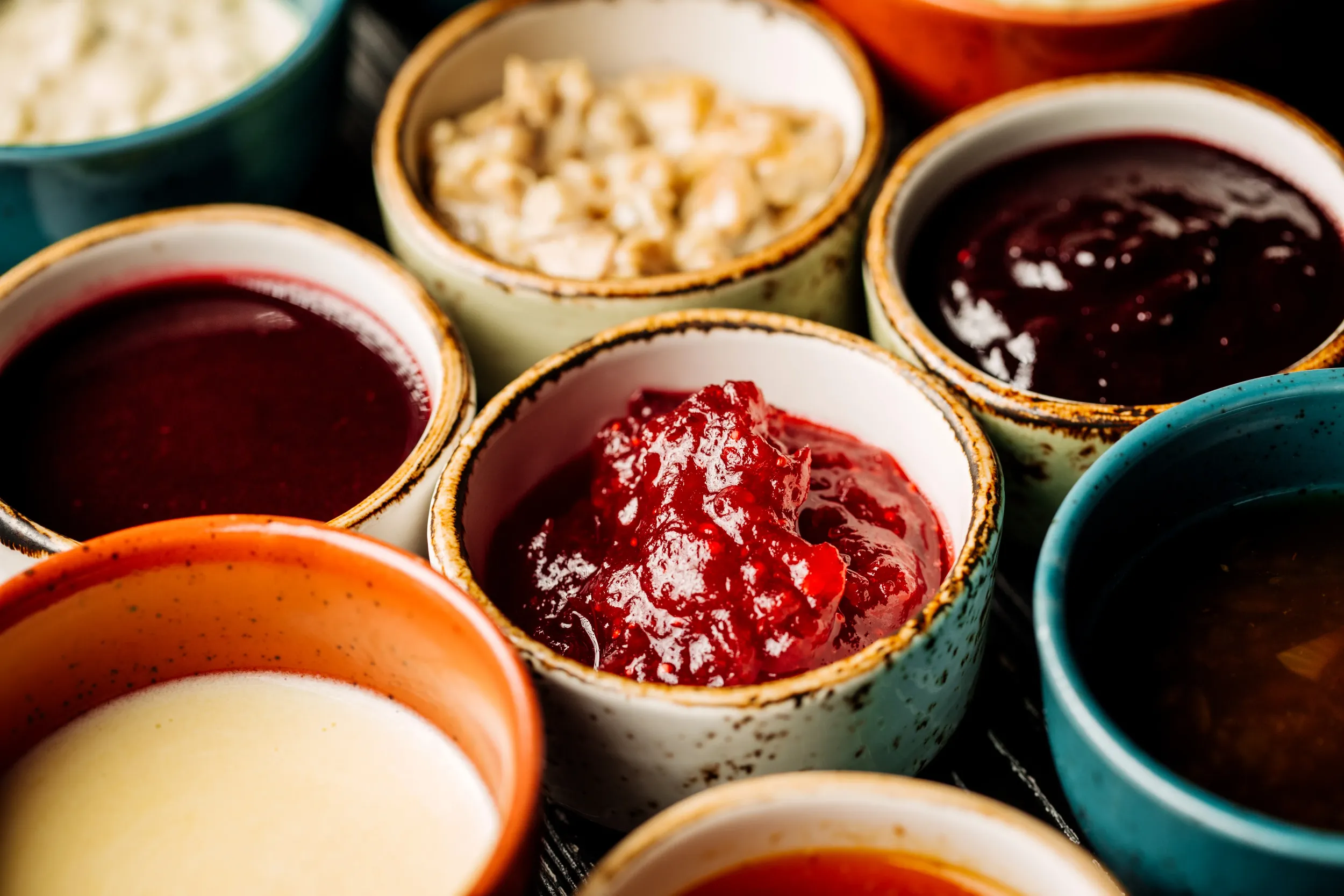set-different-sauces-black-wooden-background